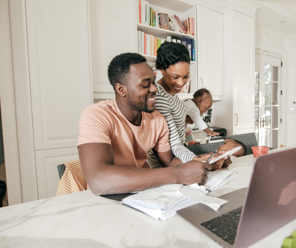 parents doing finances with kids in background