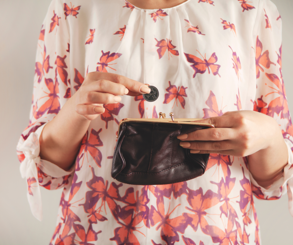 woman putting coin in purse