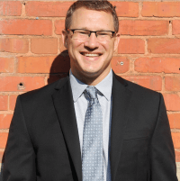 Professional headshot of Adam Hollowell