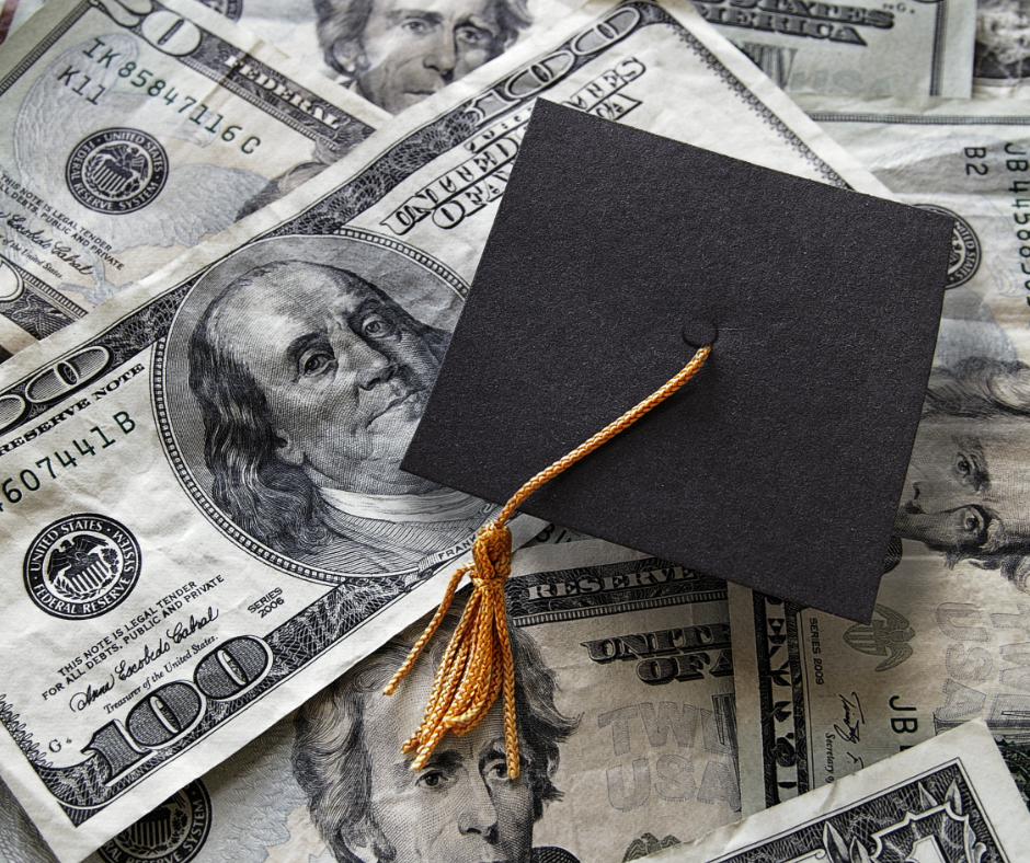 graduation cap atop 100 dollar bills