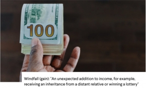 a hand holding a stack of $100 bills