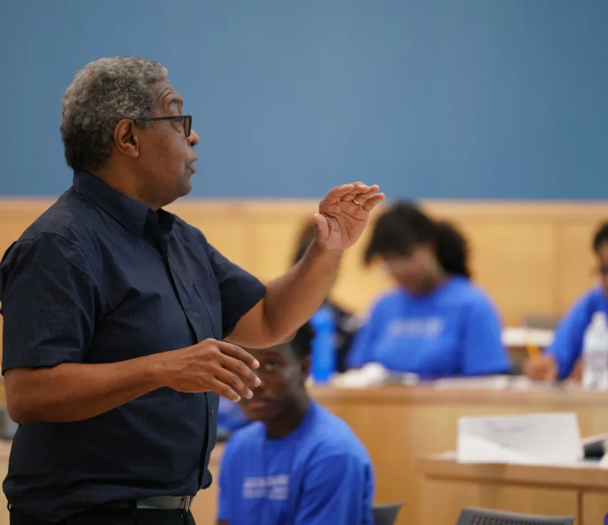 Dr. Darity speaking in front of a group of students