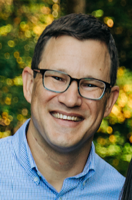 Professional headshot of Adam Hollowell