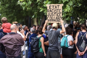 group of protesters with one holding up a sign