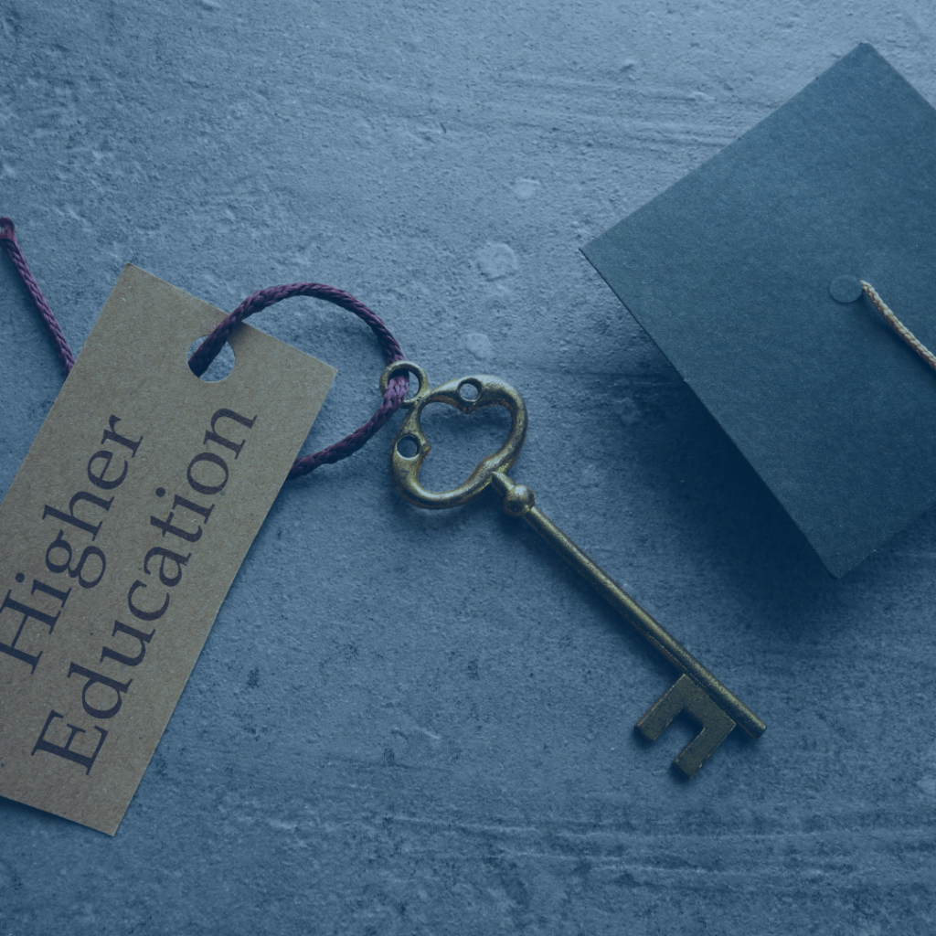an older key with a piece of rope tied at the top that has tag that reads "higher education", and a graduation cap