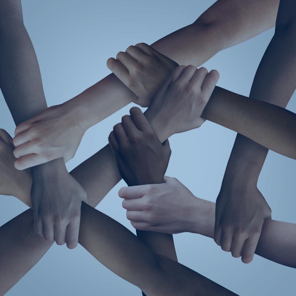 zoomed in group of forearms and hands overlapping and grabbing other arms