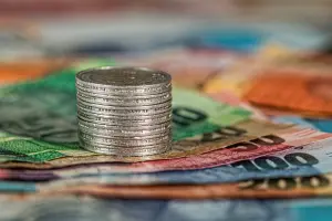 a stack of coins on paper money