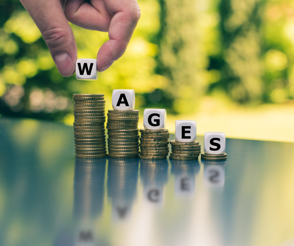stacks of coins descending in amount with "wages" spelled in blocks on top of them