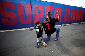 a man and a child taking a knee