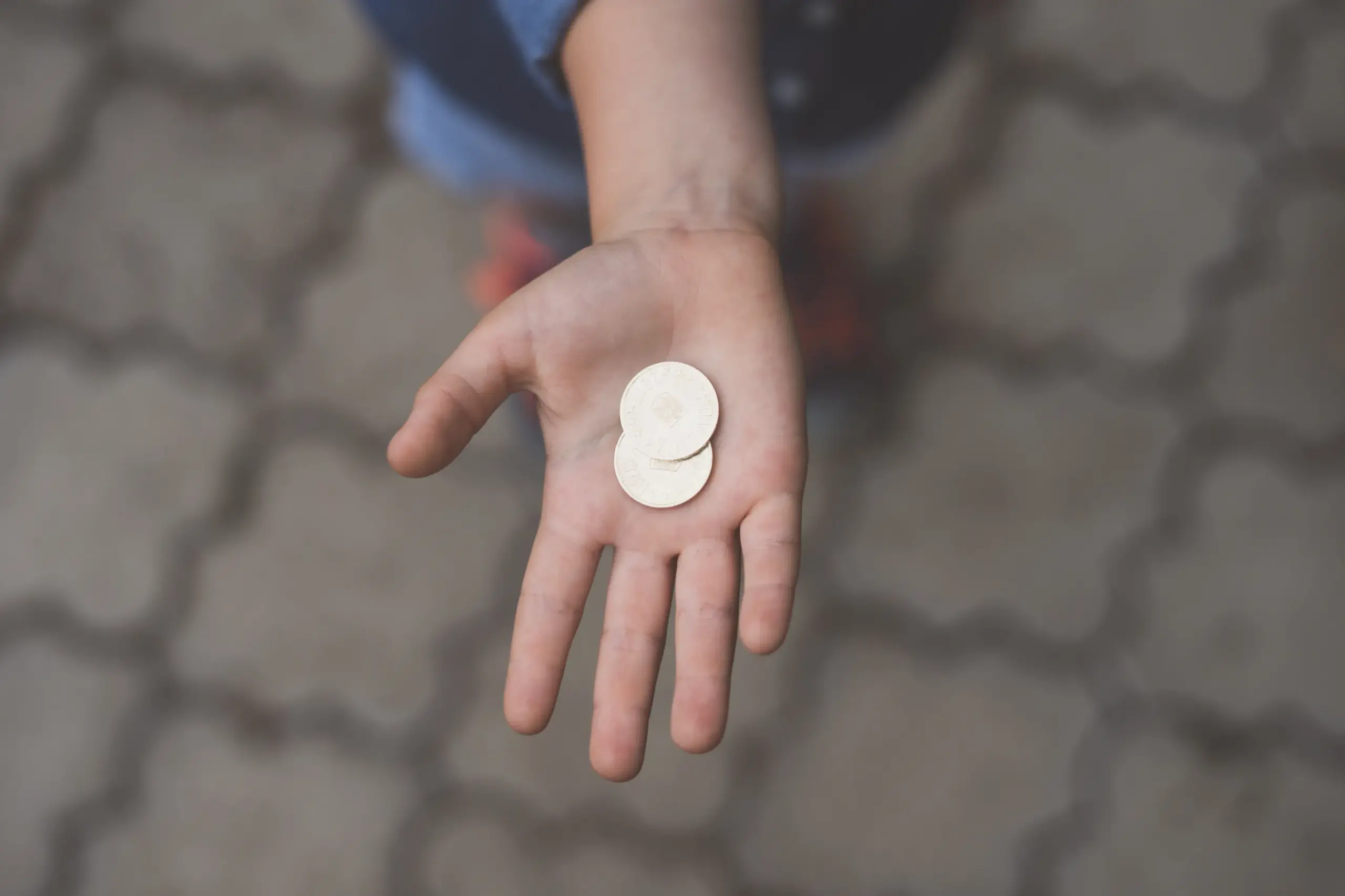 hand holding two coins