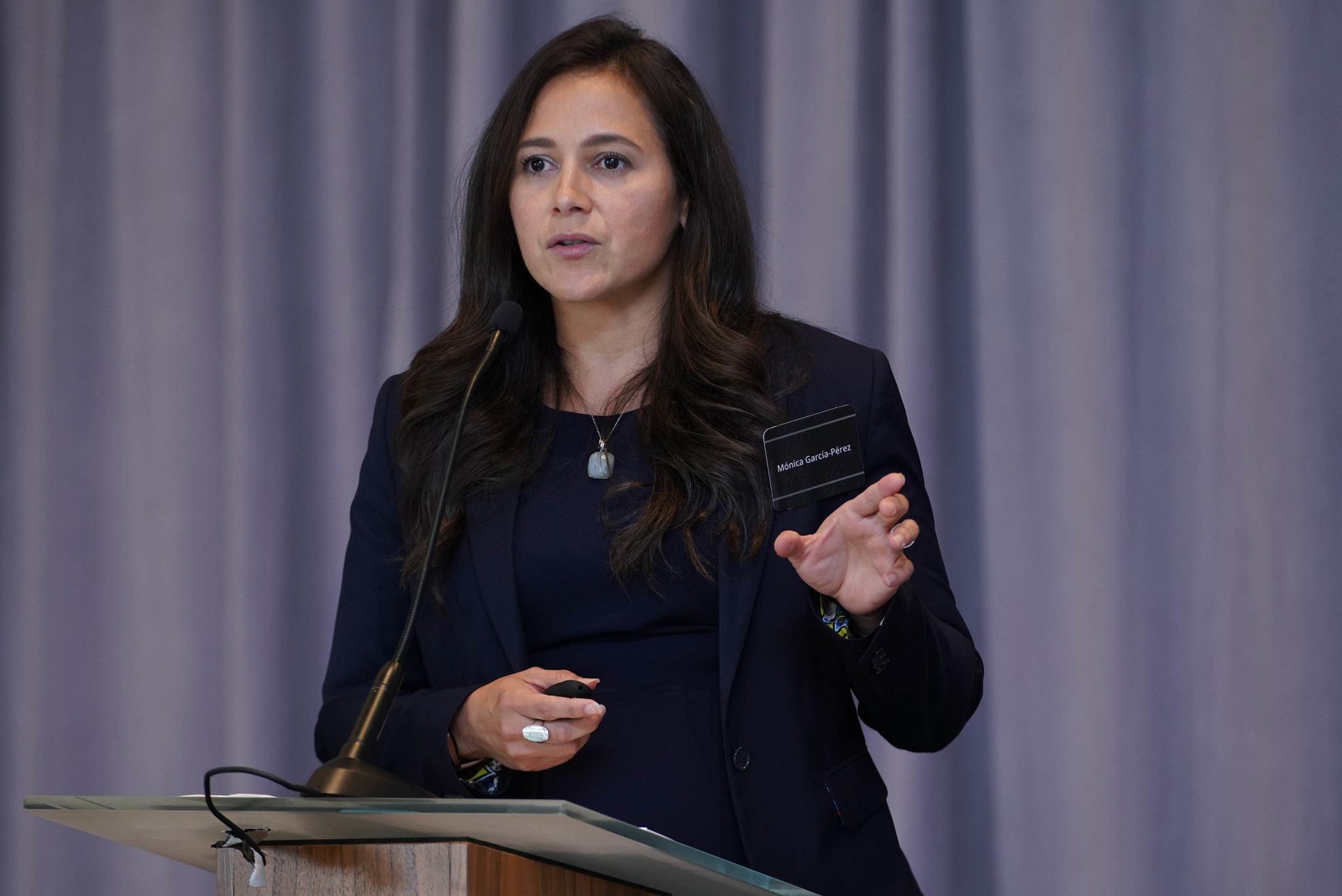 Monica Garcia-Perez presenting behind a podium