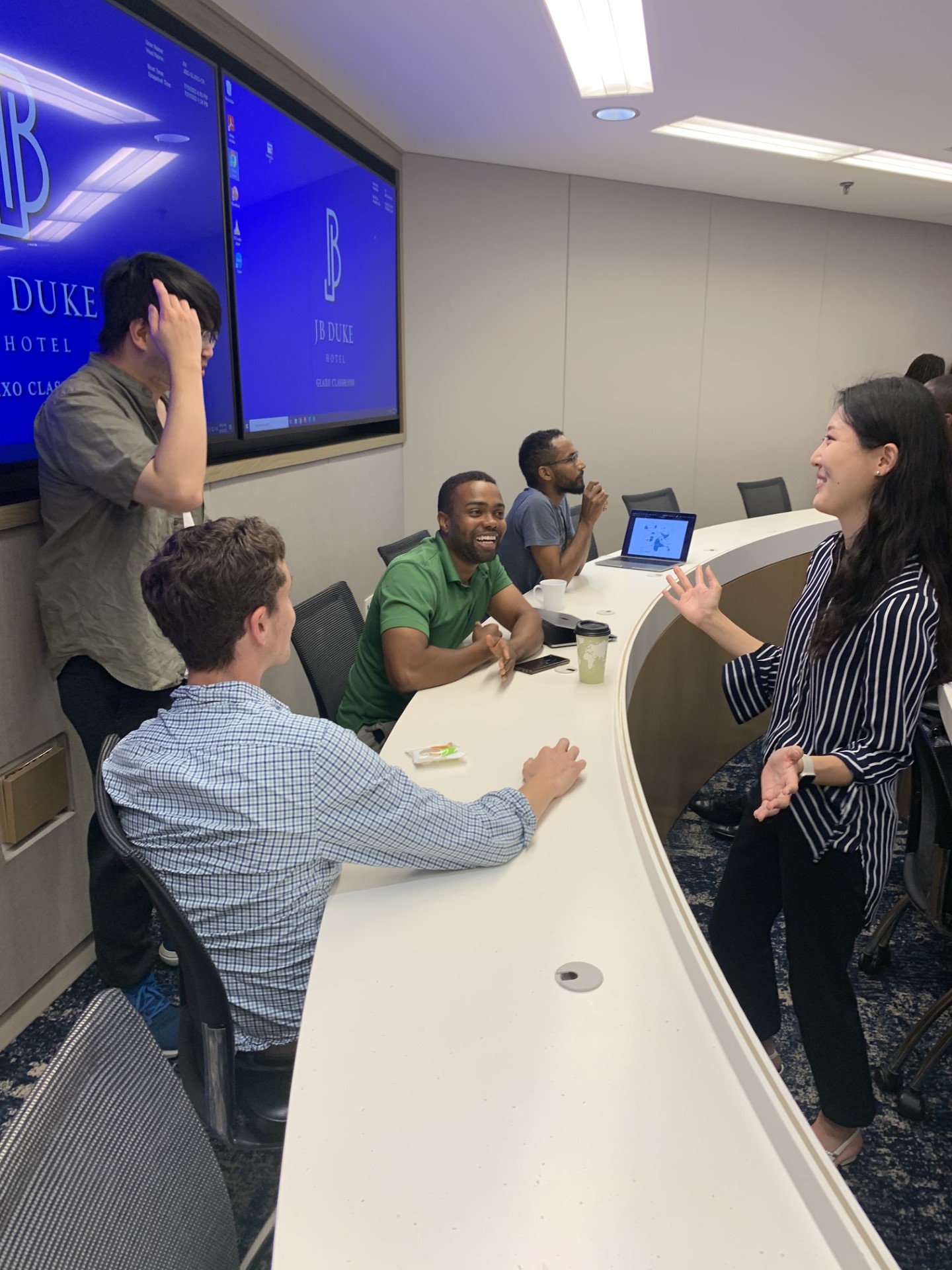 postdoctoral fellows talking with each other in a circle