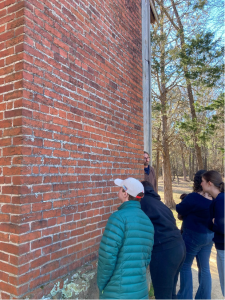 At Horton Grove, students view fingerprints of the formerly enslaved on bricks set 173 years ago, as well as what is believed to be a child's footprint, positioned at head height.