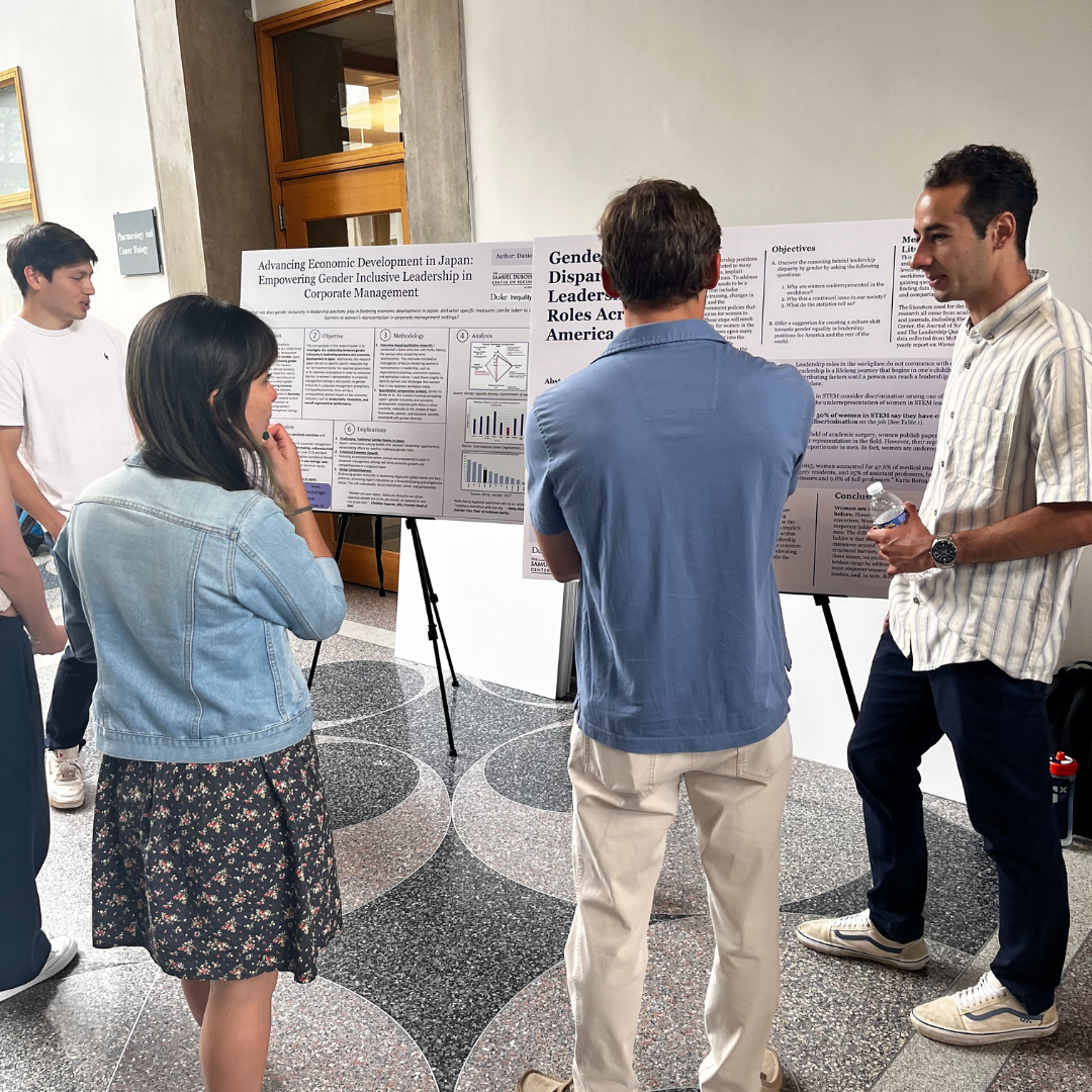 Students walk around to posters during the 2024 GIRI Capstone